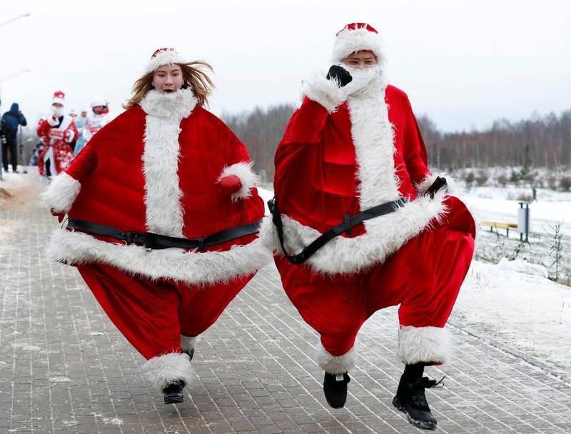 Belarusians dressed as Santa Claus take part in the country's first Santa Run around a lake in Minsk. Reuters