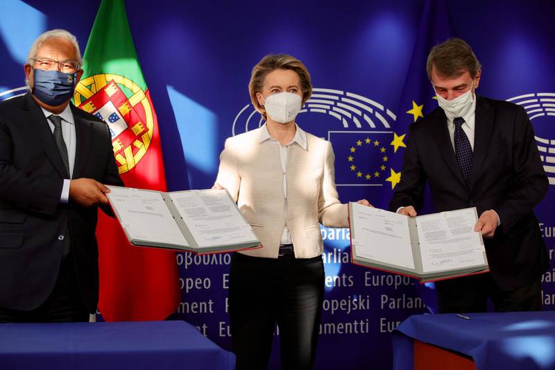 epa09006269 Portugal's Prime Minister Antonio Costa (L), European Commission President Ursula von der Leyen (C) and European Parliament President David Sassoli pose for photographers after a signing of the EU Recovery and Resilience Facility document, designed to help to stem the economic impact of COVID-19, at the European Parliament building in Brussels, Belgium, 12 February 2021.  EPA/OLIVIER MATTHYS / POOL