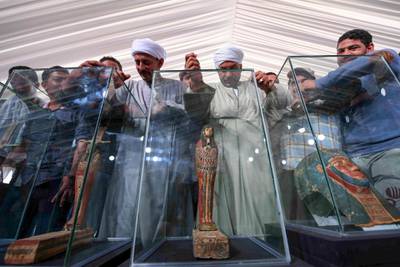 Funerary masks on display during the unveiling of an ancient treasure trove of more than a 100 intact sarcophagi. AFP