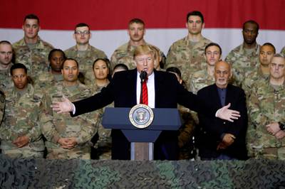 FILE PHOTO: U.S. President Donald Trump delivers remarks to U.S. troops, with Afghanistan President Ashraf Ghani standing behind him, during an unannounced visit to Bagram Air Base, Afghanistan, November 28, 2019. REUTERS/Tom Brenner/File Photo