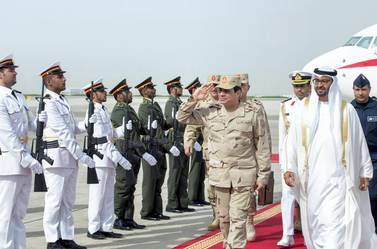A picture made available by the United Arab Emirates' official news agency WAM shows Egyptian Defense Minister and Military Chief General Abdel Fattah al-Sisi (C) saluting as he is welcomed by Sheikh Mohamed bin Zayed Al Nahyan Crown Prince of Abu Dhabi (R) upon his arrival in Abu Dhabi on March 11, 2014. AFP PHOTO/WAM/HO == RESTRICTED TO EDITORIAL USE - MANDATORY CREDIT "AFP PHOTO / HO / WAM" == NO MARKETING NO ADVERTISING CAMPAIGNS - DISTRIBUTED AS A SERVICE TO CLIENTS === (Photo by HO / WAM / AFP)