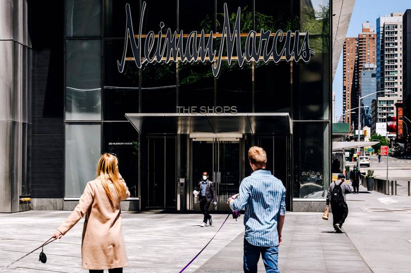 Pedestrians pass in front of Neiman Marcus Group Inc. store in Hudson Yards in New York, U.S., on Tuesday, May 5, 2020. Many retailers are losing their grip with much of the economy shuttered by coronavirus lockdowns. And even as some states move to reopen, many Americans are hesitant to go back into brick-and-mortar establishments. Photographer: Nina Westervelt/Bloomberg
