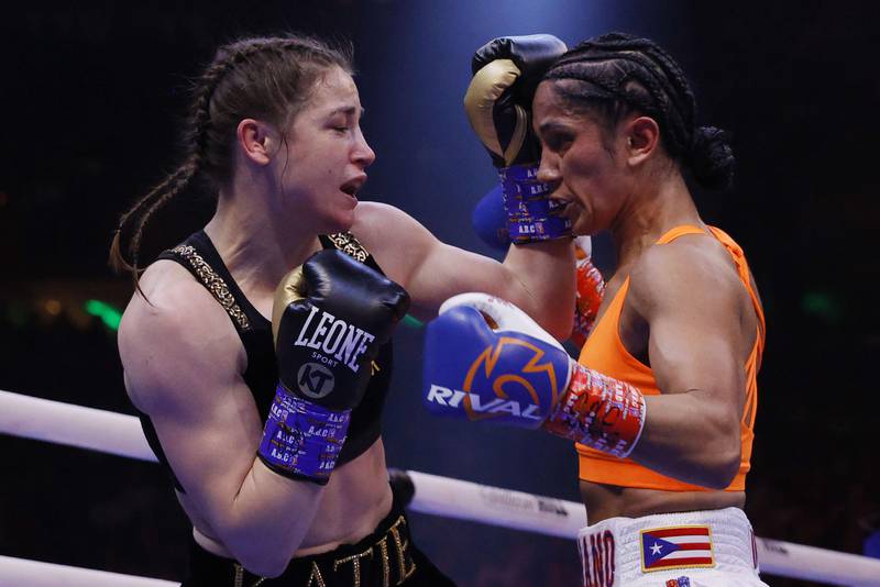 Katie Taylor trades punches with Amanda Serrano. AFP