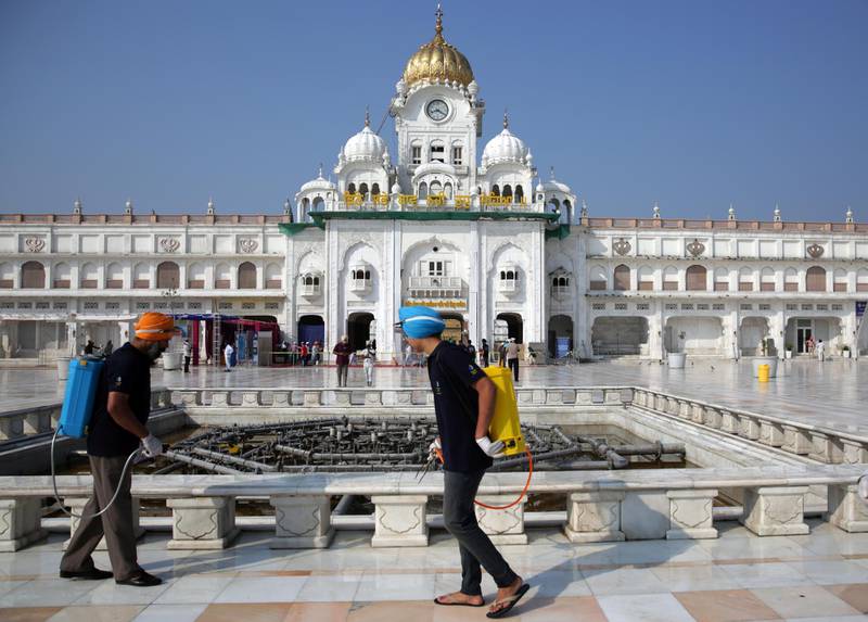 Workers sanitise area surrounding the Golden Temple, the holiest of Sikh places, in Amritsar, India.  EPA