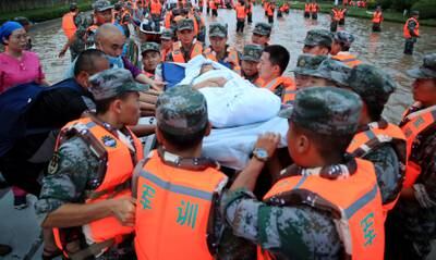 Rescuers evacuate people from a hospital in Zhengzhou.