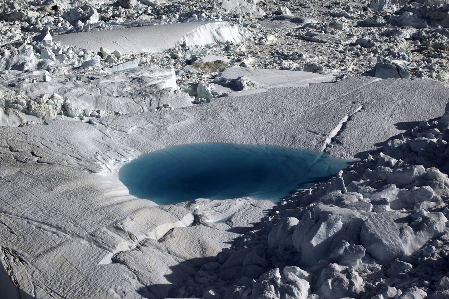 A large melt pool forms in the Ilulissat ice fjord below the Jakobshavn Glacier, at the fringe of the vast Greenland ice sheet. AP