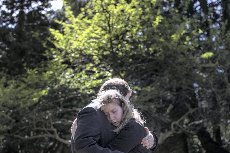 IPSWICH, ENGLAND - MAY 05: The son of the late Eric Stonestreet, Daniel and daughter Victoria embrace after the service for their father at Ipswich Crematorium on May 5, 2020 in Ipswich, England. Eric Stonestreet, a 69-year-old father of two, died of Covid-19 on April 13, 2020. A British Army veteran with the 1st Battalion Royal Green Jackets, Eric served in Guyana, Hong Kong, Germany and five tours of duty in Northern Ireland during the Troubles. Though Eric had suffered with PTSD, his family said he had no underlying health problems. He left behind his son Daniel and daughter Victoria. In keeping with the vast majority of services across the UK, only a handful of people ‚Äì in this case six ‚Äì were allowed to attend the service, due to the government‚Äôs social distancing guidelines. Such rules have placed an extra layer of burden on grieving families who are unable to share their collective grief in the company of family and friends. (Photo by Dan Kitwood/Getty Images)