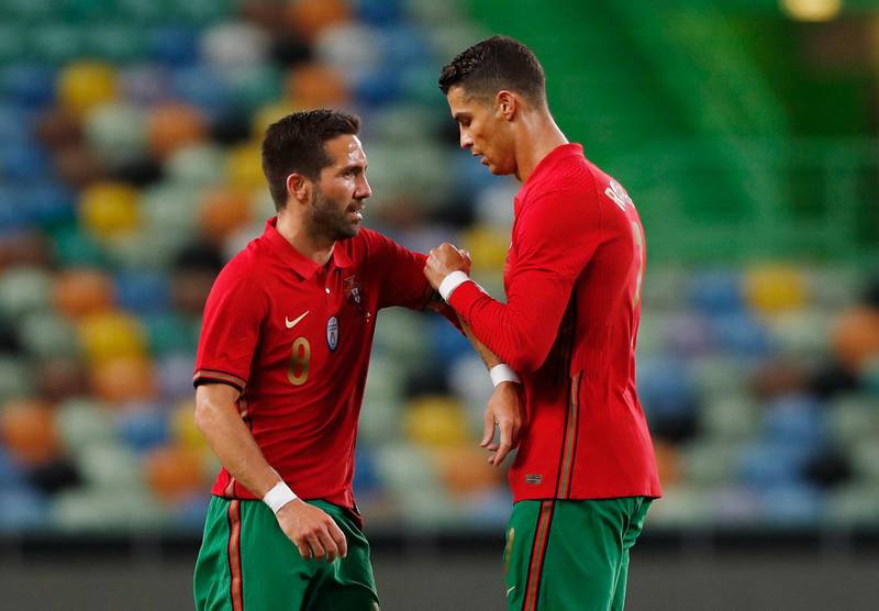 Portugal's Cristiano Ronaldo shakes hands with Joao Moutinho as he walks off to be substituted. Reuters
