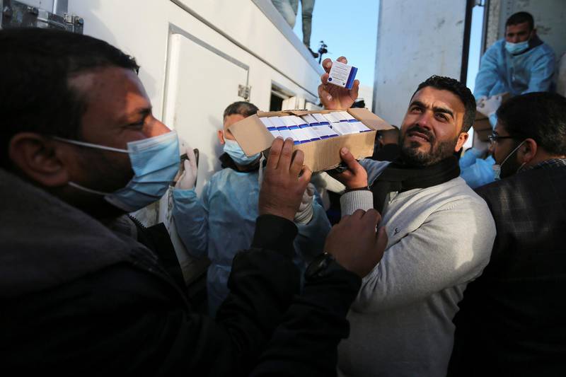 A Palestinian health worker displays a box of Russia’s Sputnik V vaccine donated by the UAE. Reuters