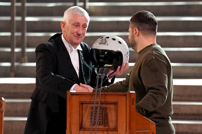 Sir Lindsay holds the helmet of one of Ukraine's most successful pilots, inscribed with the words 'We have freedom; give us wings to protect it', which was presented to him by Mr Zelenskyy. PA