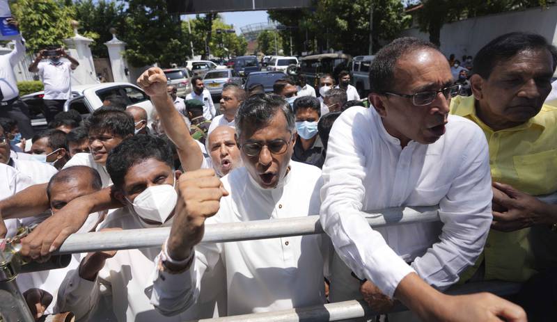 Sajith Premadasa (L) and other opposition politicians lead an anti government rally in Colombo. AP