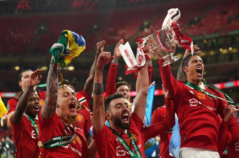 Manchester United's players celebrate with the League Cup trophy after their 2-0 victory over Newcastle United at Wembley Stadium on Sunday, February 26, 2023. PA