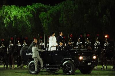 Libyan leader Muammar Qaddafi and Berlusconi arrive at a ceremony for Italia-Libya friendship day at Salvo D'Acquisto barracks, Rome, in 2010. Getty
