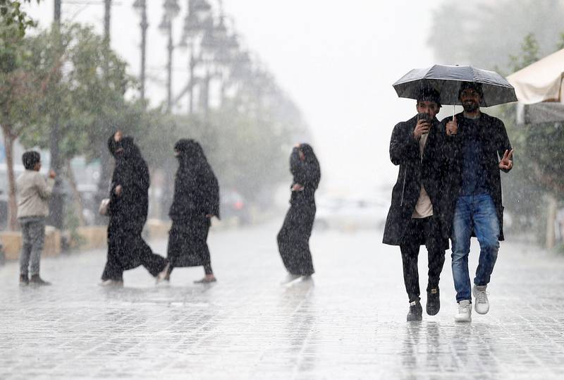 Men use an umbrella during rain in Riyadh, Saudi Arabia, February 16, 2017. REUTERS/Faisal Al Nasser