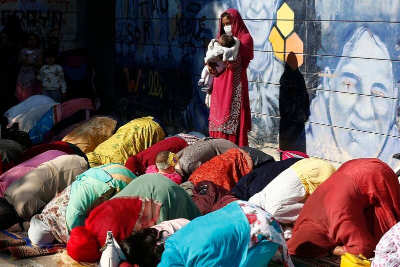 Women perform Eid Al Fitr prayers in Rome. AP