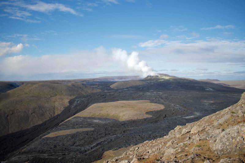The plume from the active crater and part of the 4,6 square kilometre lava field are seen from a mountain near the eruption site in Fagradalsfjall, Iceland. The volcanic eruption near the capital Reykjavik is still going strong six months after lava began flowing. AFP
