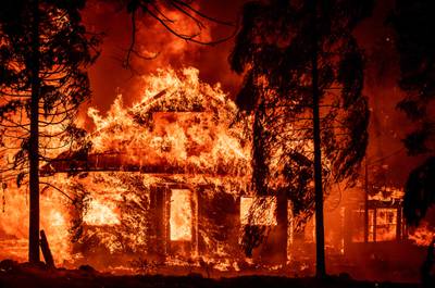 A home burns in the Indian Falls neighbourhood of Plumas County, California, one of the areas affected by the Dixie fire, which has destroyed a quarter of a million acres since July 13.