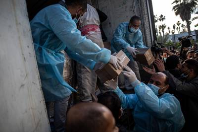 Palestinians unload a truck containing 20,000 doses of the Russian-made Sputnik V vaccine in the Gaza Strip, at the Rafah crossing border with Egypt. AP