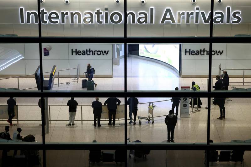 People wait at the arrivals area at terminal 2 of the Heathrow Airport. Reuters