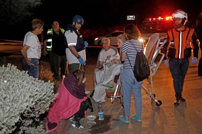 Rescuers move Israelis from their homes in Yehud, near Tel Aviv, after rockets were launched towards Israel from the Gaza Strip. AFP