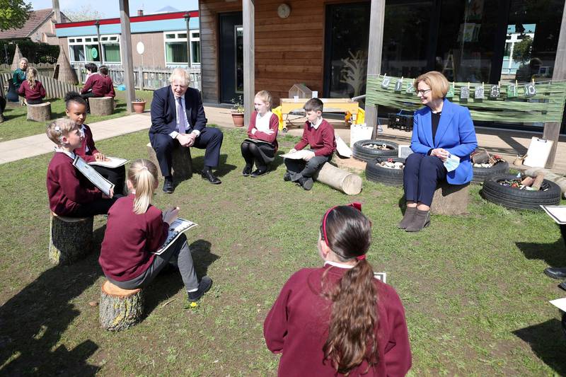 Boris Johnson and Julia Gillard speak to pupils at Cleves Cross Primary School. Reuters