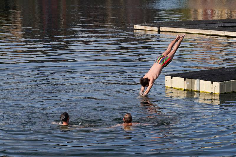 Swimmers take the plunge to escape the heat in east London. Reuters