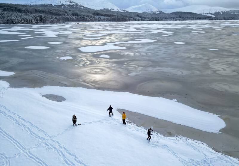 Snow, ice and bitter cold continued to grip the nation on Wednesday, as people were seen venturing on to a frozen Loch Morlich in Aviemore, Scotland. Getty Images