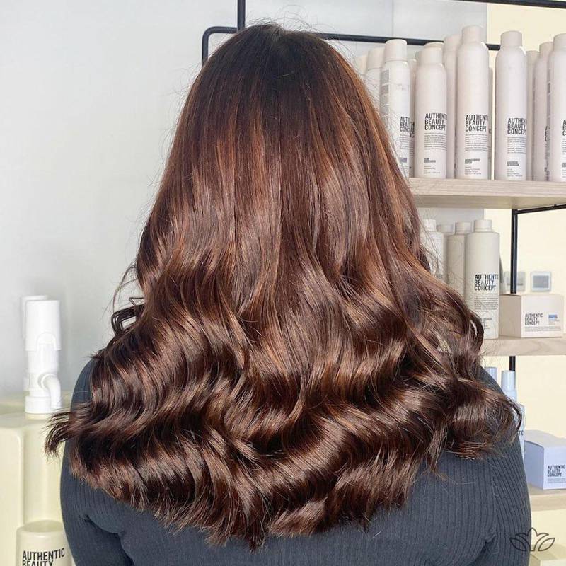 Natural, glossy brunette with depth and dimension added by way of low contrast and mid-tone highlights is a top hair colour trend for 2023. Photo: Tara Rose Salon