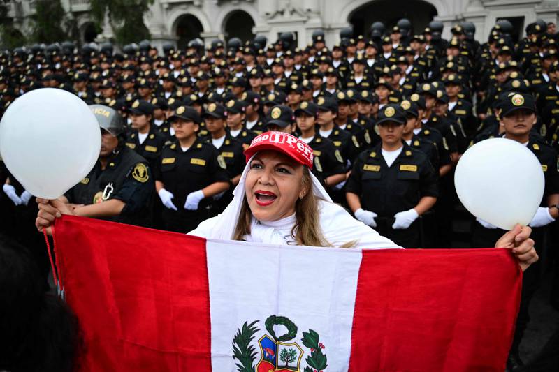 A marcher on the streets of Lima, Peru, in support of the police and military during a nationwide state of emergency following violent protests against the ousting and arrest of former president Pedro Castillo. AFP
