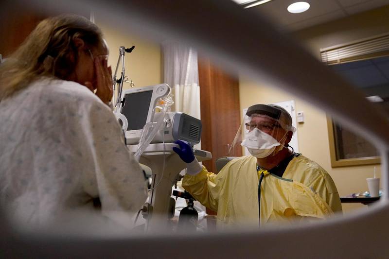 Dr Shane Wilson kneels at the bedside of a patient suffering from Covid-19 inside Scotland County Hospital in Memphis, Missouri. AP Photo