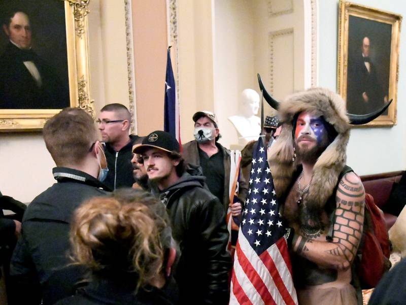 Jacob Anthony Chansley, also known as Jake Angeli, of Arizona, stands with other Trump supporters on the second floor of the US Capitol near the entrance to the Senate after breaching security defences, in Washington, on January 6, 2021. Reuters