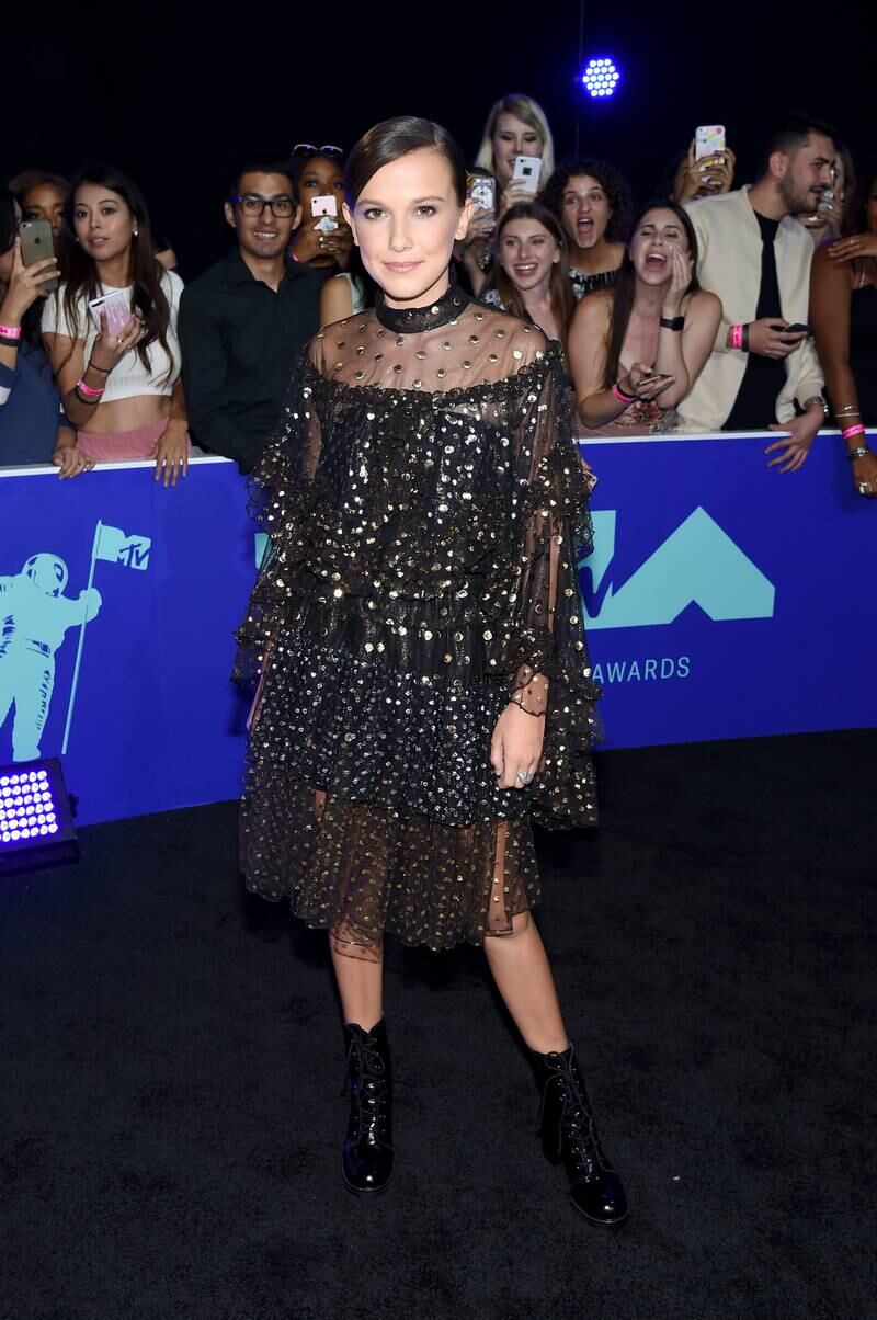 Millie Bobby Brown, wearing a tulle black and gold dress, attends the MTV Video Music Awards in Inglewood, California, on August 27, 2017. Getty Images