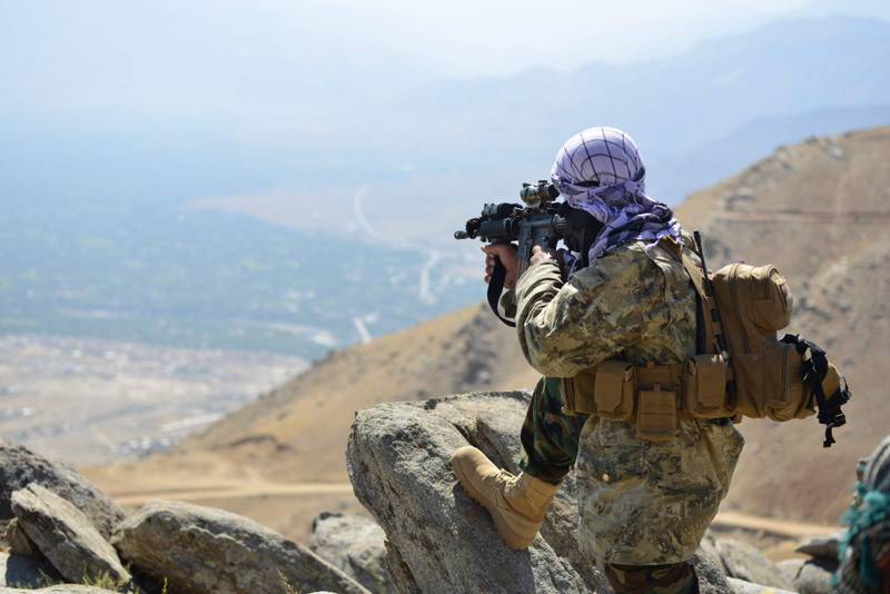 An anti-Taliban fighter takes a postion on a hilltop. Several thousand fighters are reported to be holding out against the Taliban in the region.  AFP