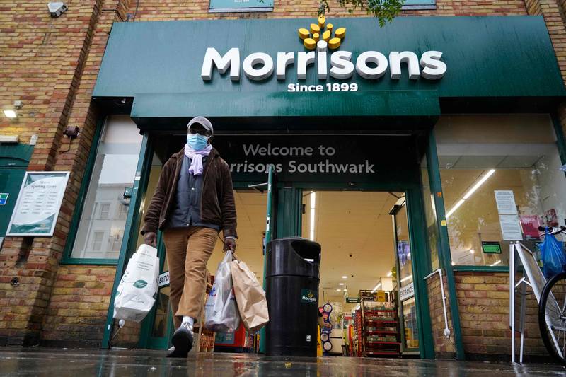 A shopper wearing a face mask leaves a Morrisons supermarket in Southwark, south London. AFP