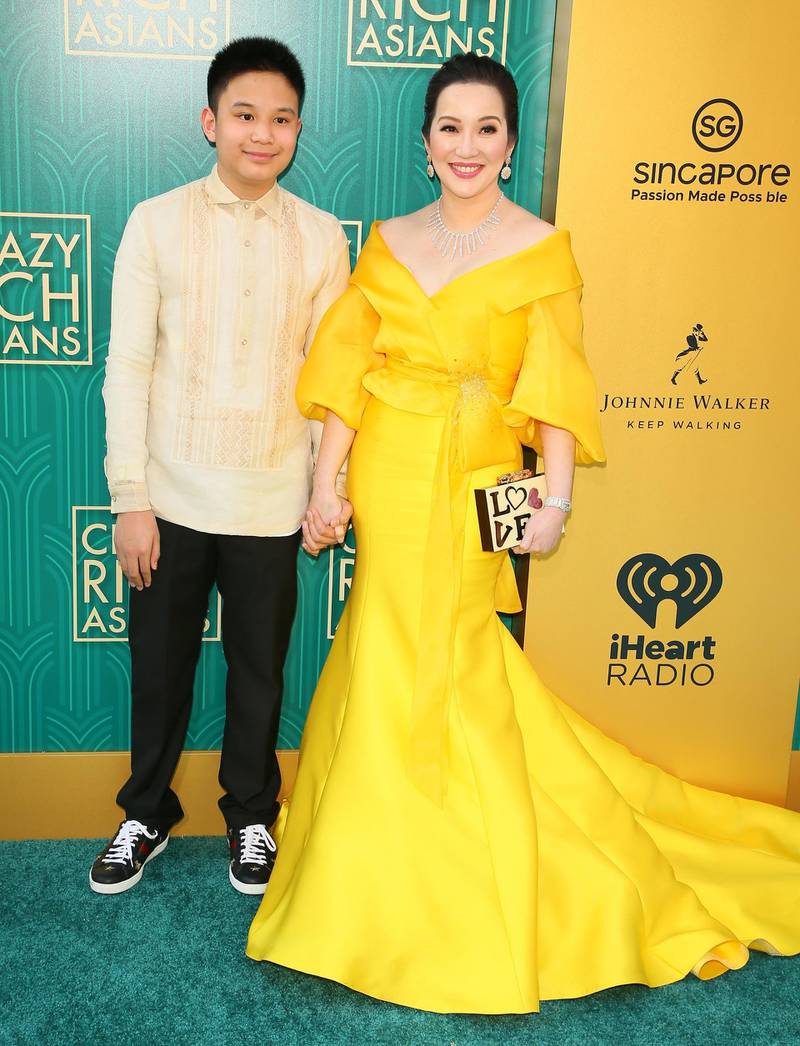 Actress Kris Aquino in a traditional-Filipina-inspired gown by Michael Levya, with her son Bimby Aquino Yap. AFP