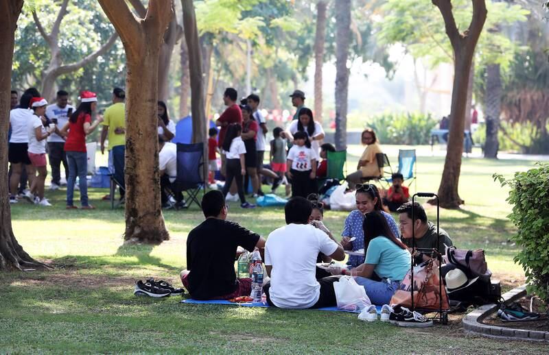 Residents relax with family and friends beneath the shade of trees at Zabeel Park, as the UAE celebrates its 51st National Day. Pawan Singh / The National