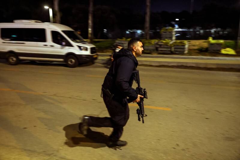 An Israeli security force member runs at the scene. ISIS has claimed responsibility for the attack. Reuters