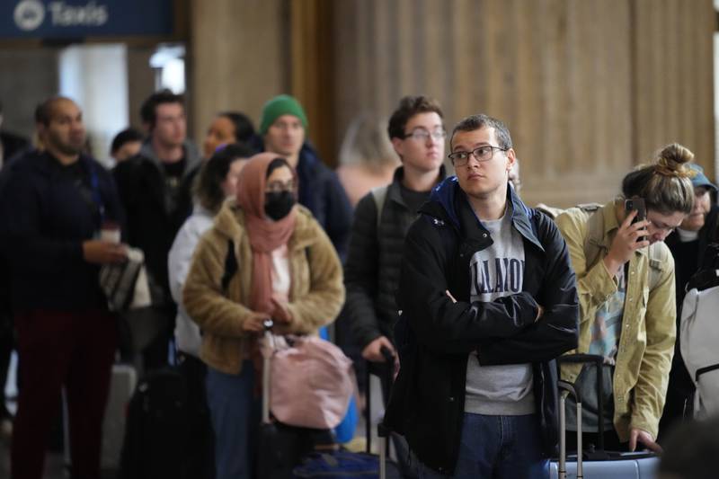 Travellers queue to board an Amtrak train. AP