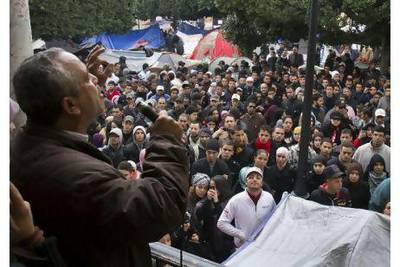 Demonstrators listen to a speaker in a protest camp in the Kasba in Tunis yesterday as unrest continued across Tunisia.