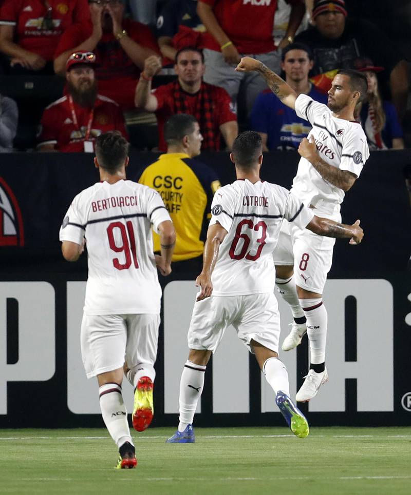 AC Milan's Suso celebrates with teammates after scoring a goal. EPA