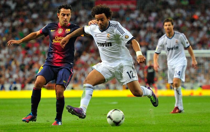  Marcelo duels for the ball with Xavi of Barcelona as Real win the Super Cup in 2012. Getty