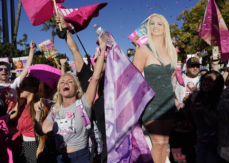 A Britney Spears supporter celebrates after a hearing concerning the pop singer's conservatorship at the Stanley Mosk Courthouse, Friday, Nov.  12, 2021, in Los Angeles.  A Los Angeles judge ended the conservatorship that has controlled Spears' life and money for nearly 14 years.  (AP Photo / Chris Pizzello)