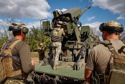 Ukrainian troops fire a howitzer towards Russian forces at a position in the Donetsk region. Reuters