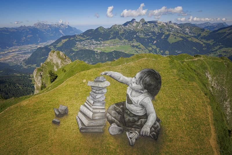 A picture taken with a drone shows a giant biodegradable land-art painting entitled 'Vers l'equilibre' (Towards balance) by French-Swiss artist Saype near the summit of the Grand Chamossaire mountain, Switzerland. The fresco was created using pigments made out of charcoal, chalk, water and milk proteins. EPA
