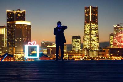 A man looks at his mobile phone on the rooftop area of Osanbashi Pier in Yokohama.  AFP