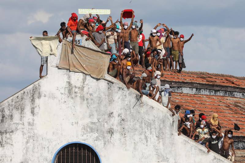 A group of remand prisoners stage a protest on the roof of the Welikada Remand Prison complex in Colombo, Sri Lanka.  EPA