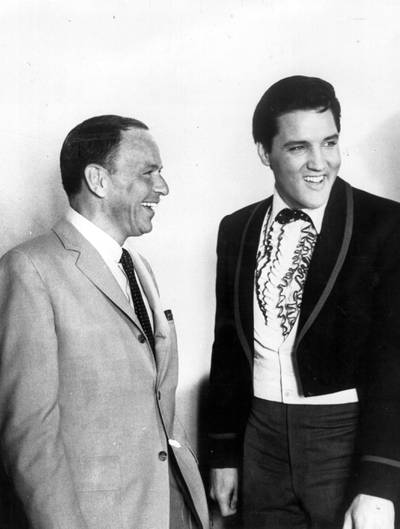Singer Frank Sinatra and Elvis share a joke in Hollywood, in 1965