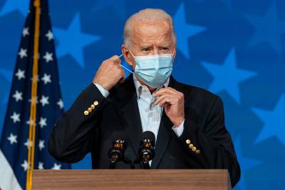 Democratic presidential candidate former Vice President Joe Biden removes his face mask to speak at The Queen theater in Wilmington, Delaware. AP Photo