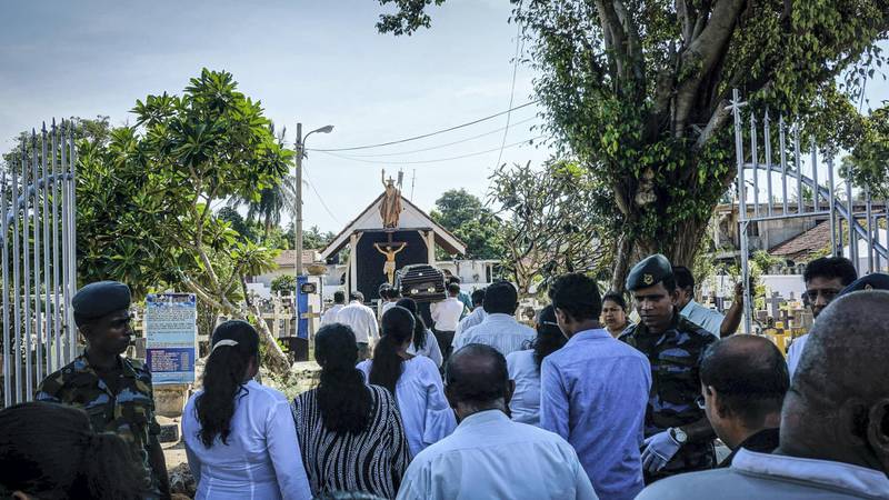 Mourners enter Bolowalana cemetery for a burial in Negombo, Sri Lanka, April 23, 2019. Jack Moore / The National. 