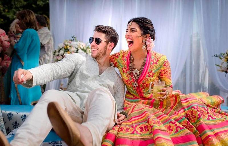 In this Friday, Nov. 30, 2018 handout photo released by Raindrop Media, Bollywood actress Priyanka Chopra and Nick Jonas celebrate during a mehendi ceremony, a day before their wedding, at Umaid Bhawan in Jodhpur, India. (Raindrop Media via AP)